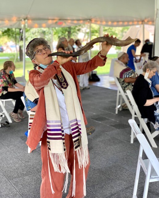 Suri blowing a shofar